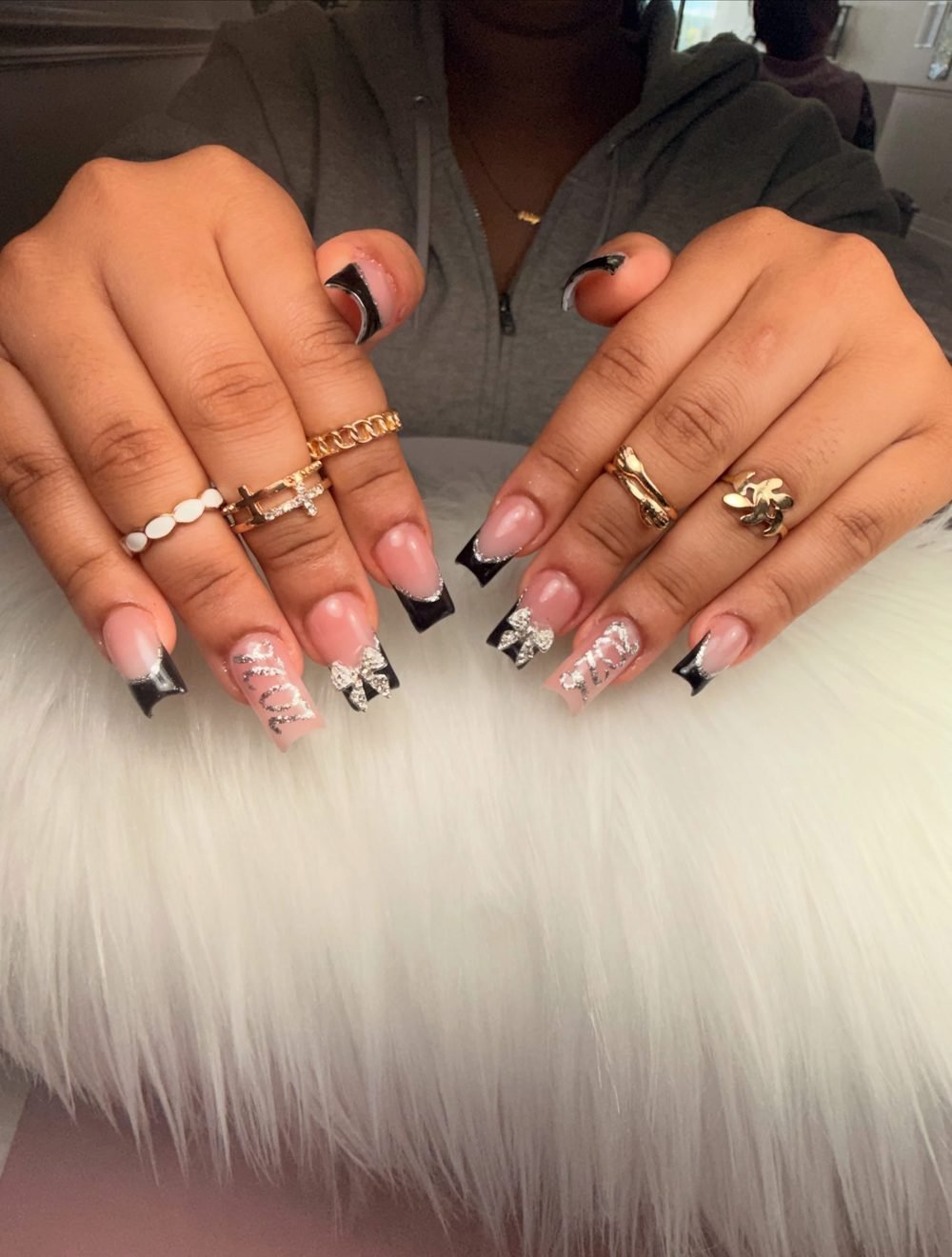 Black French tips with silver glitter bows and lettering