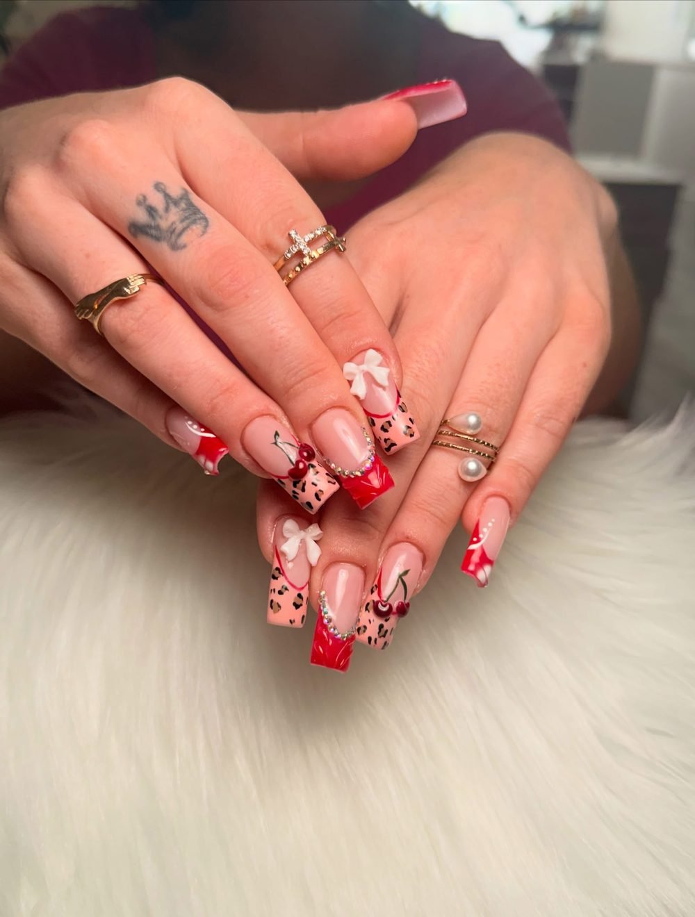 Red French tips with cherry charms and leopard print accents